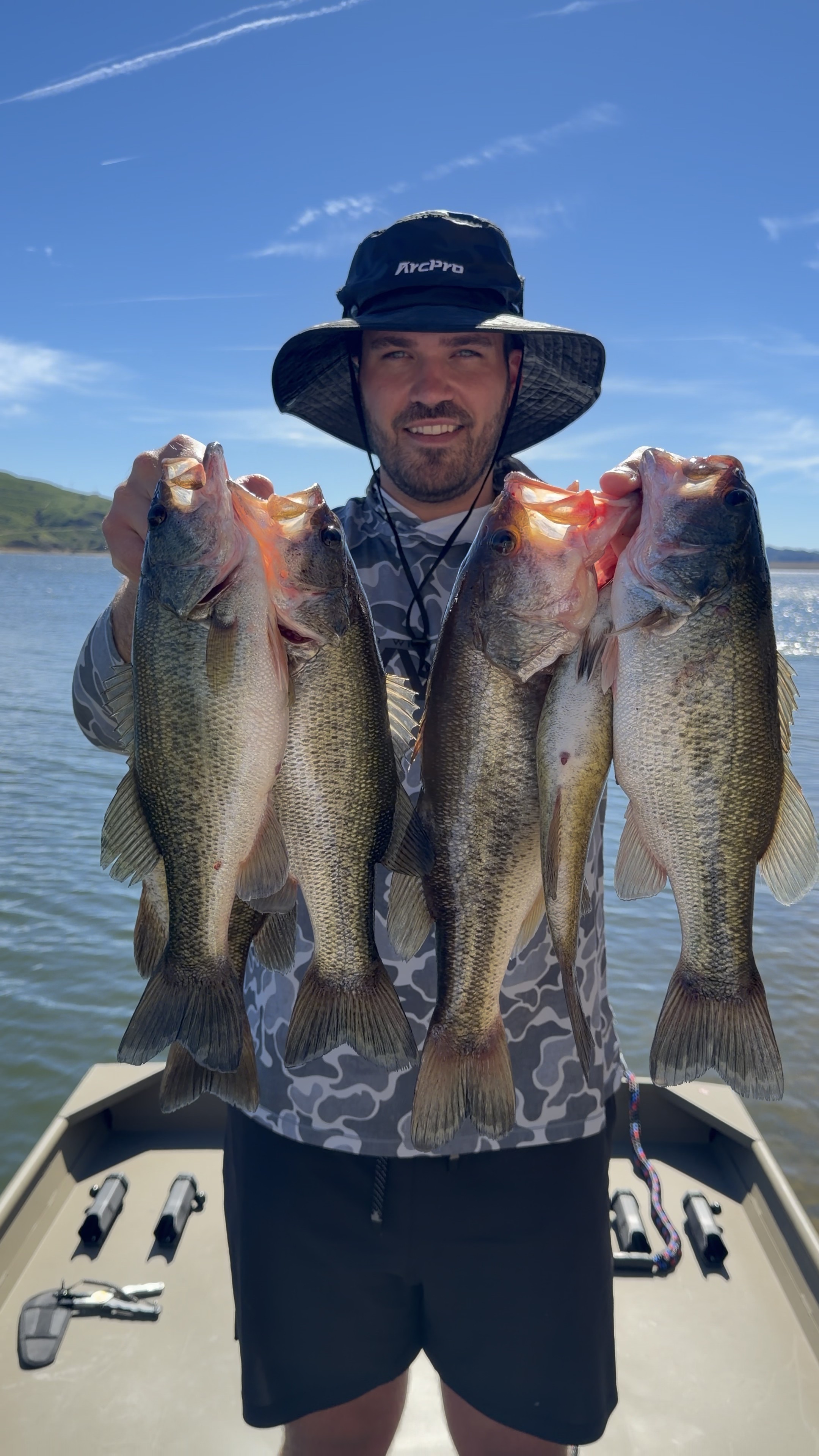 TJ LeClair with several largemouth bass caught from a jon boat