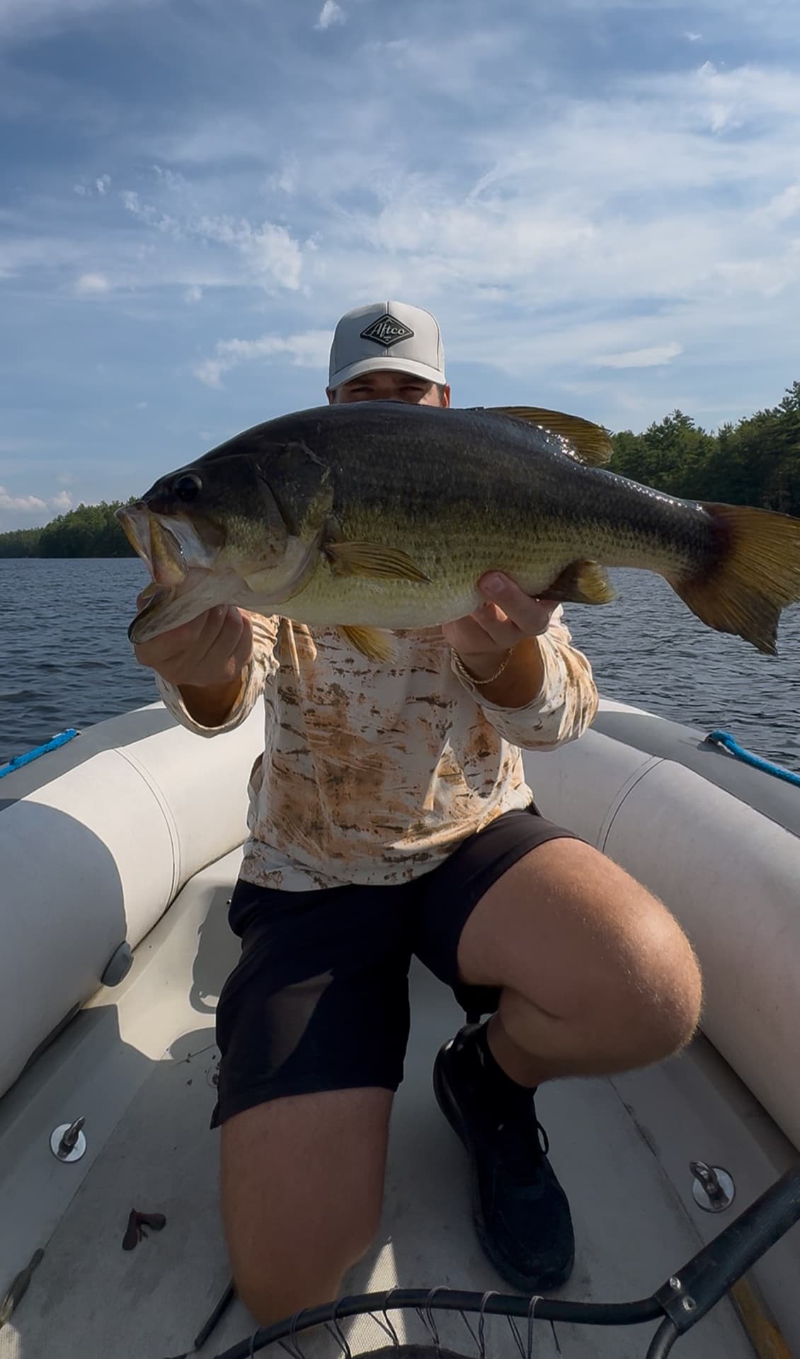 TJ LeClair holding a large largemouth bass on the boat